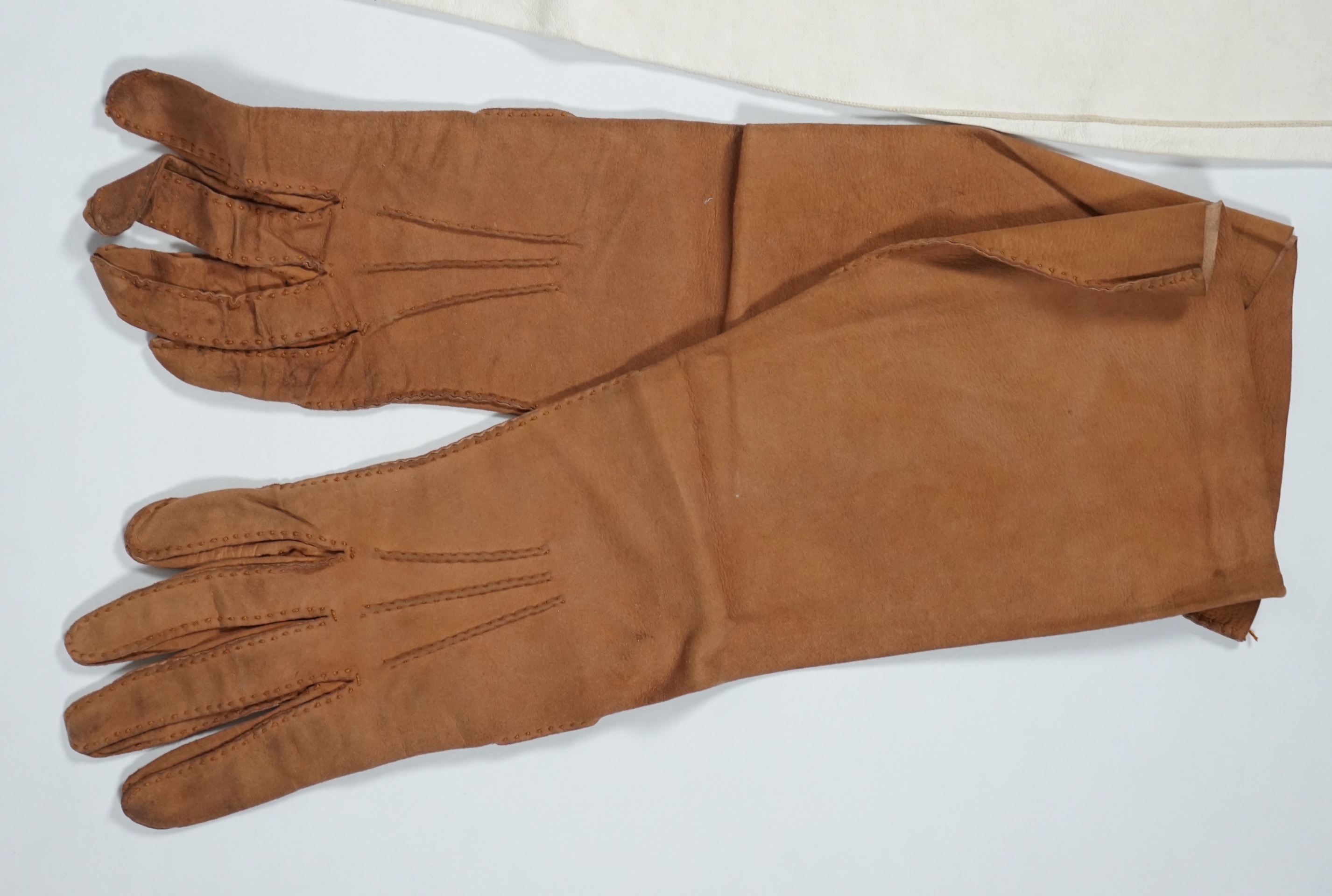 A pair of lady's Hermès skin gloves, boxed and three other pairs of gloves